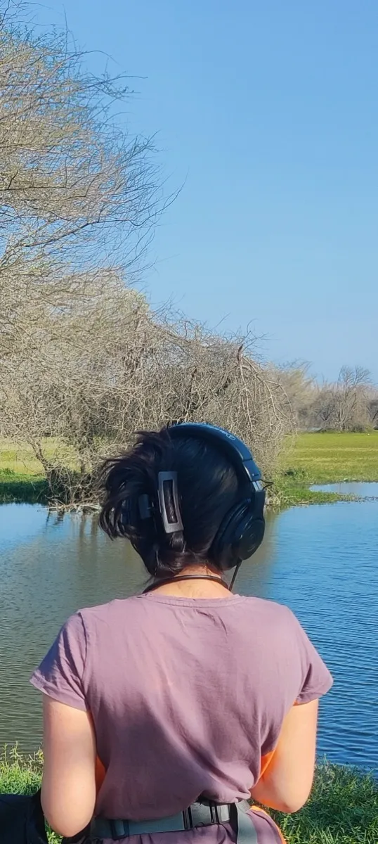 Listening on headphones by the water