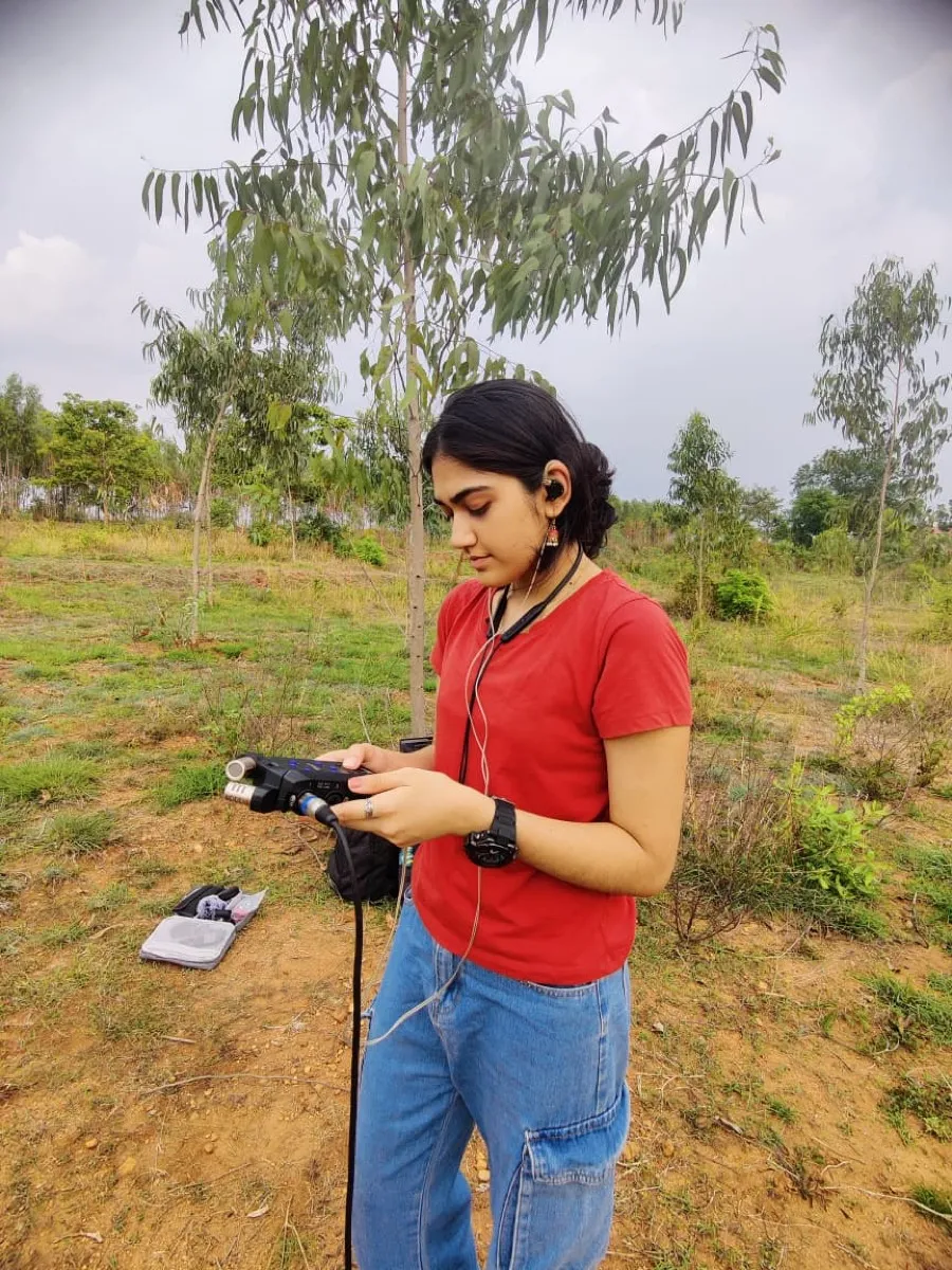 Recordist checking levels in the field